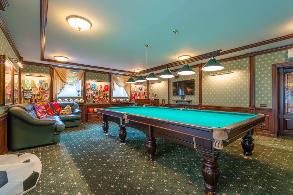 Elegant billiard room with vibrant decor and classic furnishings.